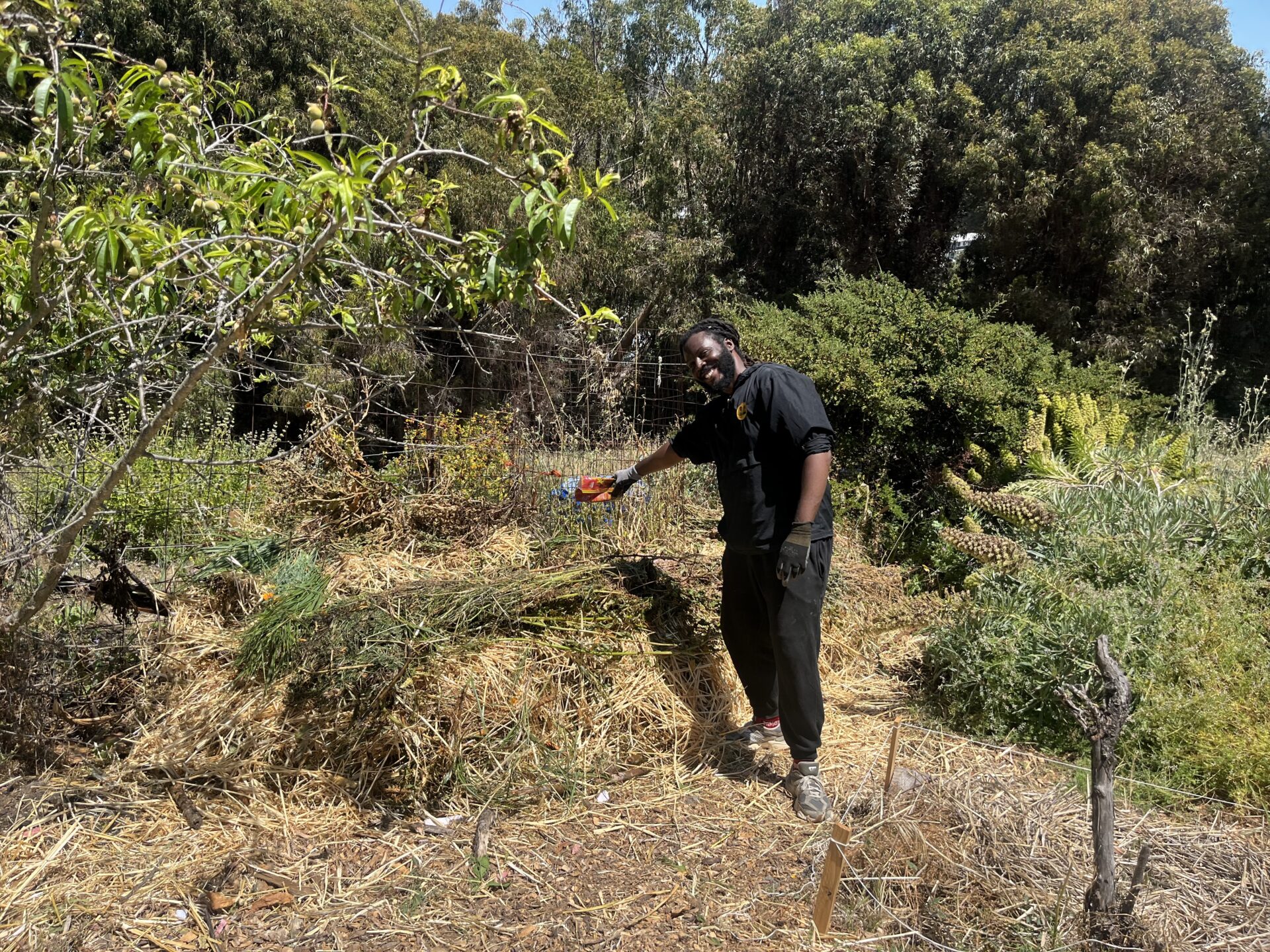 Donté Clark, a Rudy Lozito fellow pours nutrient supplements into the SPICE pile. 