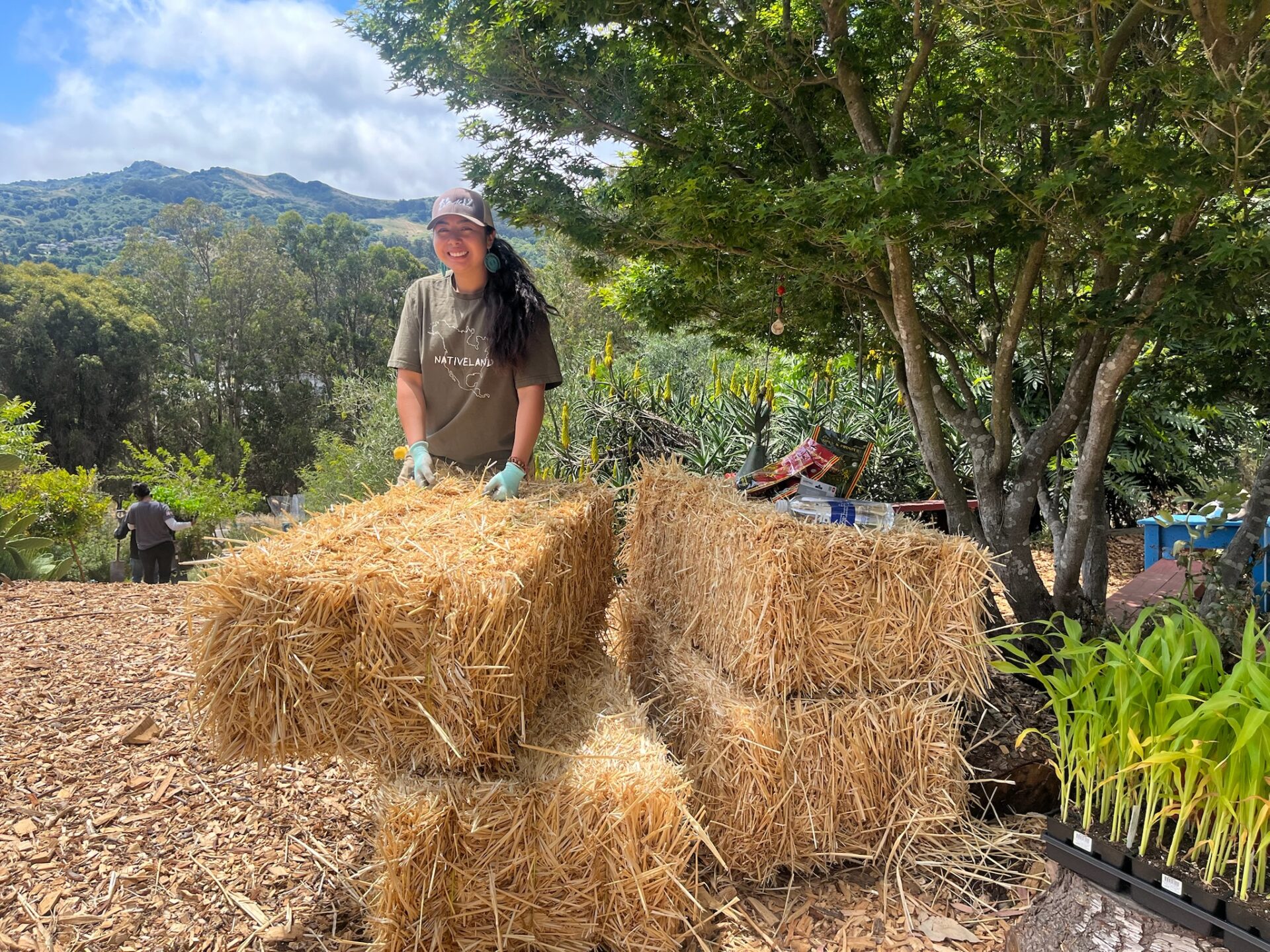 Daniela Tabora shifts hay. 