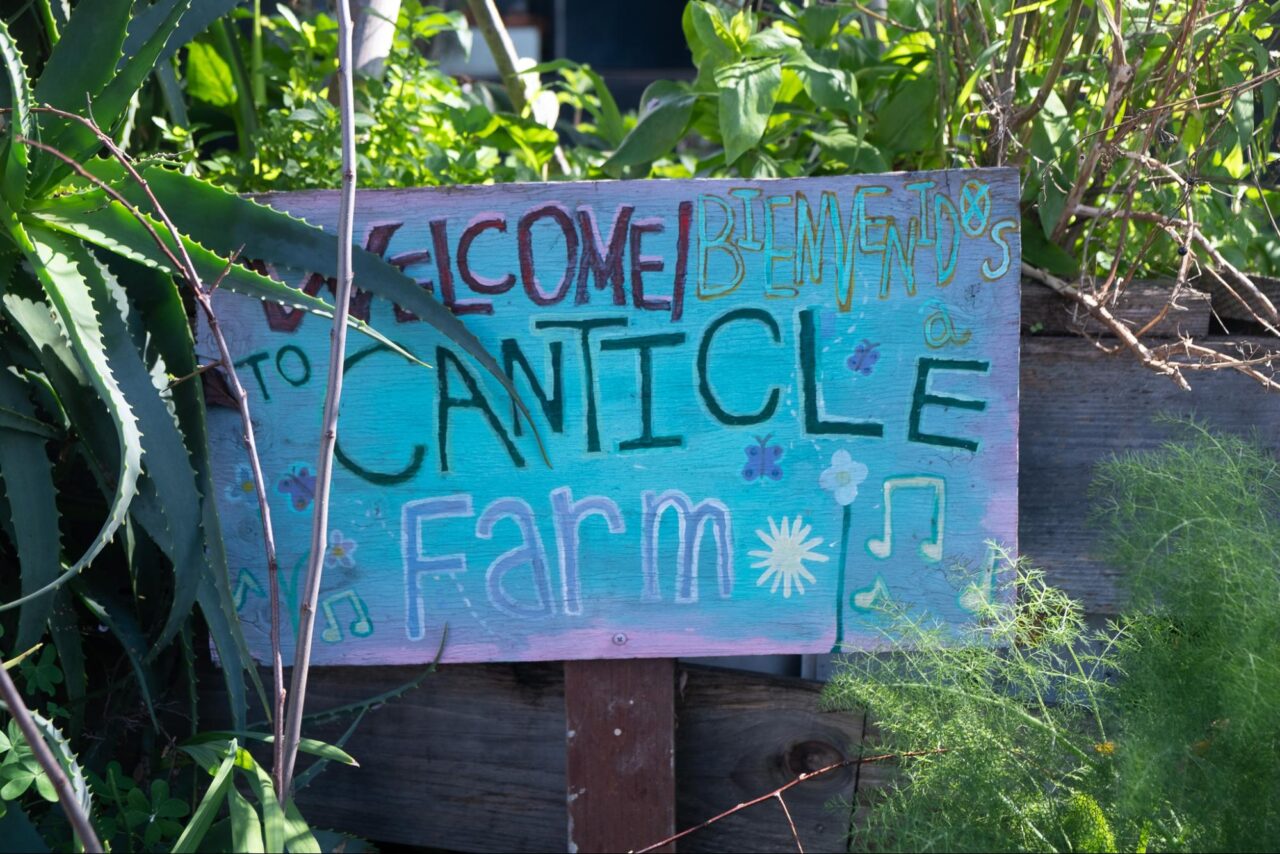 Colorful sign reading "Welcome to Canticle Farm"