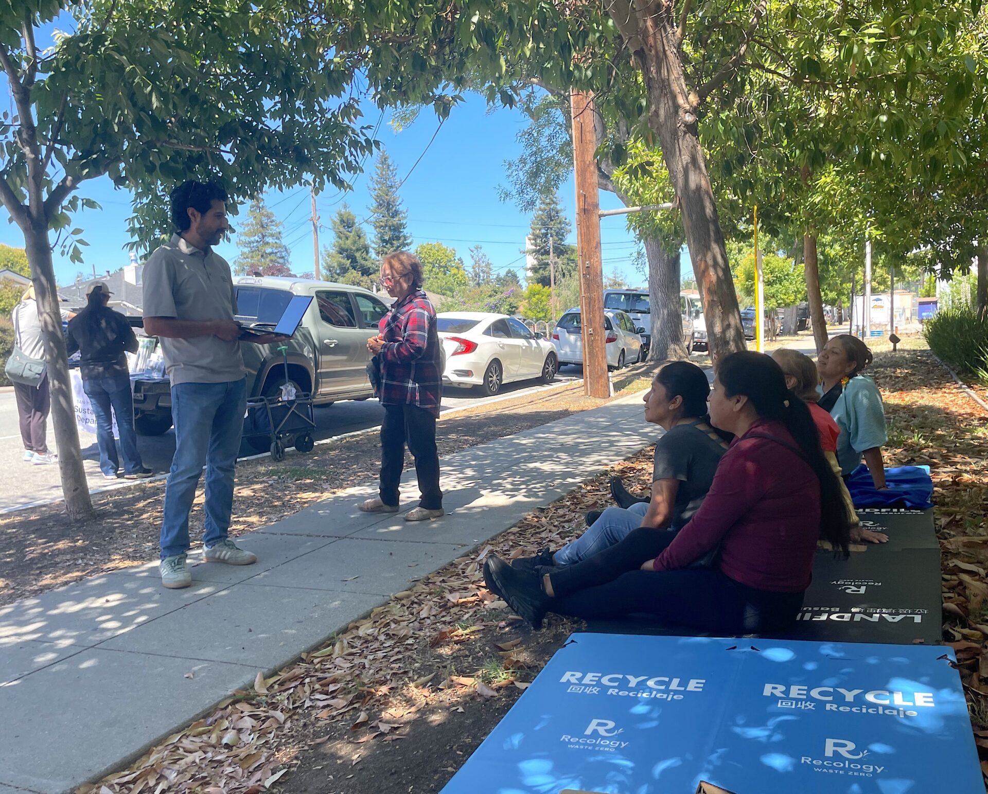 Kids rest in shade of healthier street trees at June 2026 flea market in North Fair Oaks. Photo: CRC